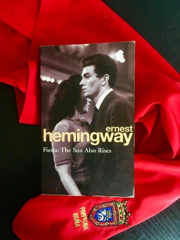 Hemingway book against red scarf