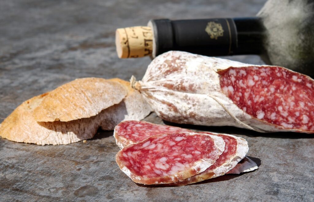 cold meat, wine bottle and bread - Málaga festivals