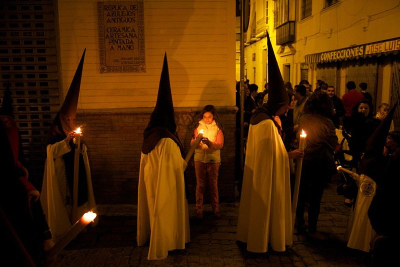 Penitents carrying candles during Holy Week in Seville